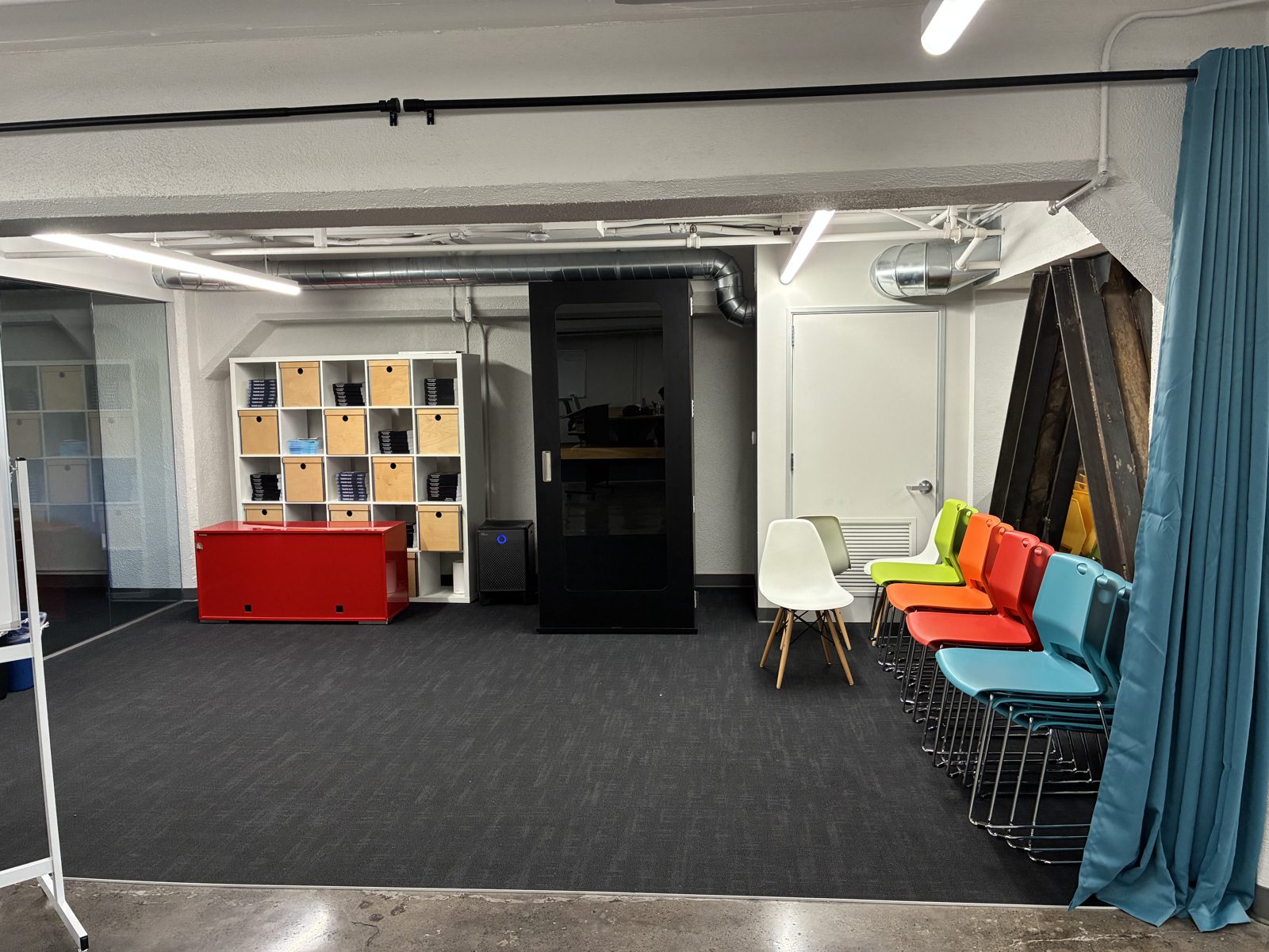 The big room — talks, demo nights, and chairs that pack away.